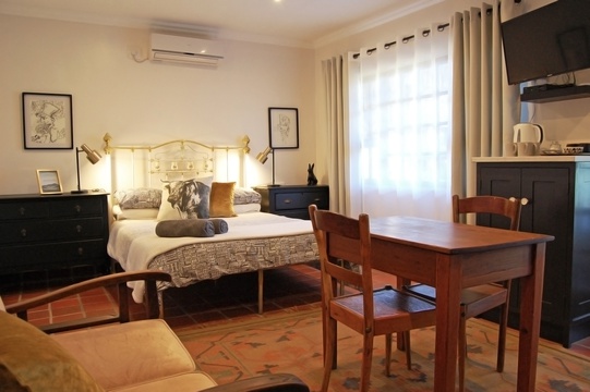 Comfortable but spacious room with up-scaled antique furniture, rustic qualities and terracotta flooring creating a farmhouse feel but with all the modern amenities one needs to have a great evening. 